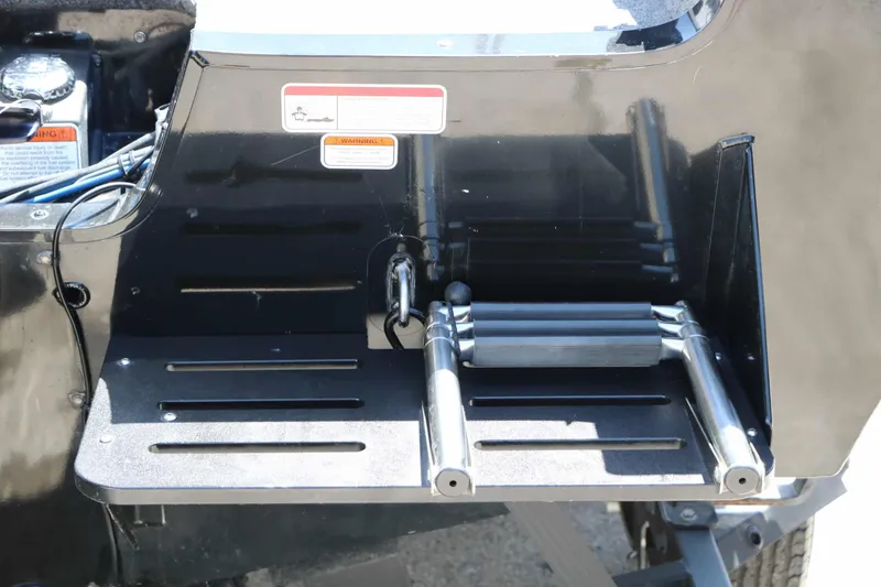 Slide: The Image of A black boat with an integrated swim ladder and safety stickers on the rear. - 7