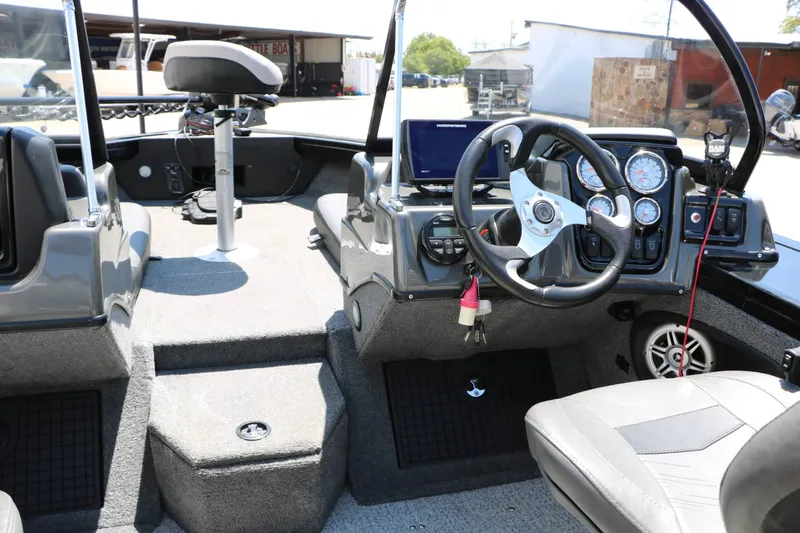 Slide: The Image of The image shows the cockpit of a 2020 Tracker Targa V 19 Combo with steering and instruments. - 27