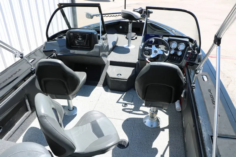 Slide: The Image of The image shows the cockpit of a 2020 Tracker Targa V 19 Combo with gray seats and a helm console. - 23