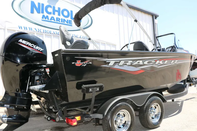 Slide: The Image of A black 2020 Tracker Targa V 19 Combo boat on a trailer in front of a building. - 4