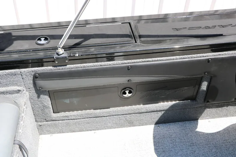 Slide: The Image of Close-up of a boat deck with gray carpeting and black storage compartments. - 47