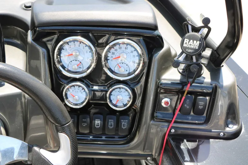 Slide: The Image of The image shows the dashboard of a Tracker Targa V 19 Combo boat with multiple gauges and a RAM mount. - 35