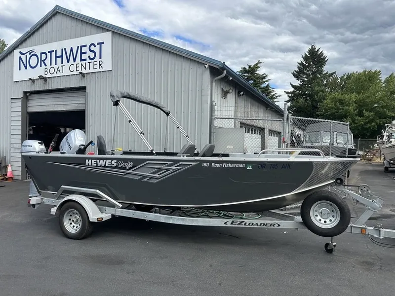 Slide: The Image of A gray 2021 Hewescraft Open Fisherman 180 OF boat on a trailer outside a boat center. - 9