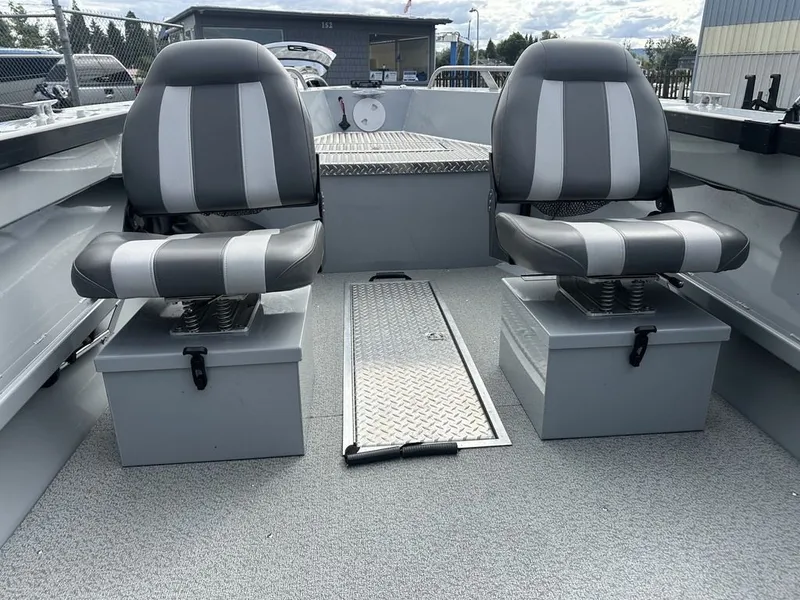 Slide: The Image of The image shows the interior of a 2021 Hewescraft Open Fisherman 180 OF with two gray seats. - 6