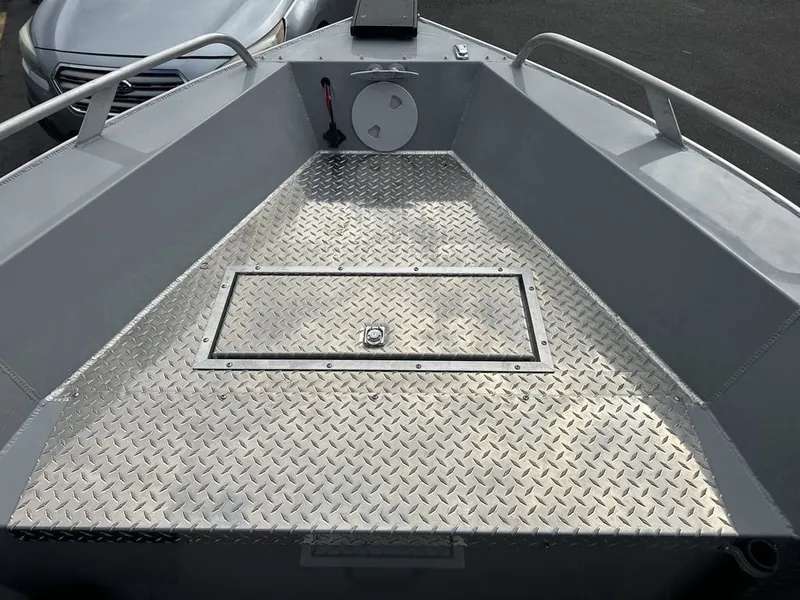 Slide: The Image of The image shows the bow of a 2021 Hewescraft Open Fisherman 180 OF with a non-slip metal floor. - 4