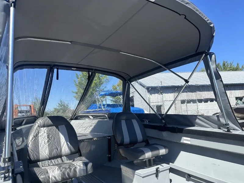 Slide: The Image of The image shows the interior of a 2021 Hewescraft Open Fisherman 180 OF with two seats. - 11