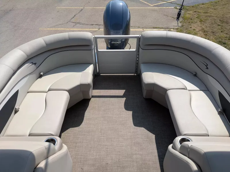 Slide: The Image of The image shows the interior of a 2019 Bennington 23 SSRXP pontoon boat with beige seating. - 11