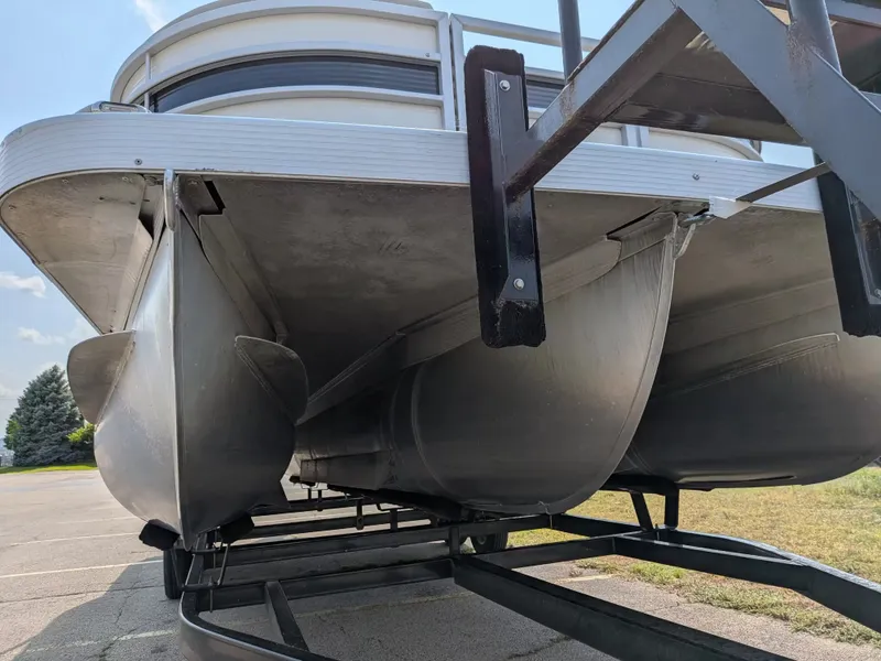 Slide: The Image of A 2019 Bennington 23 SSRXP pontoon boat on a trailer, featuring aluminum hulls and sturdy structure. - 6
