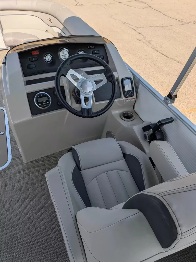 Slide: The Image of The image shows the cockpit of a 2019 Bennington 23 SSRXP with a sleek steering wheel and instruments. - 14