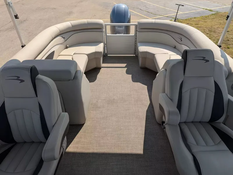 Slide: The Image of The image shows the interior of a 2019 Bennington 23 SSRXP pontoon boat with beige seating. - 10