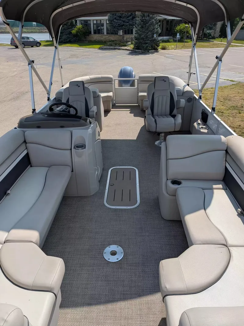 Slide: The Image of The image shows the interior of a 2019 Bennington 23 SSRXP pontoon boat with gray seating. - 9