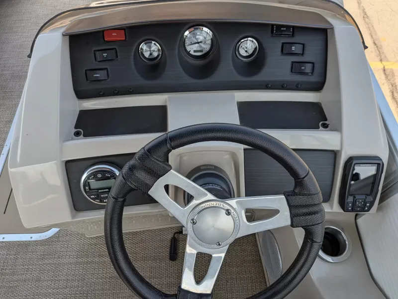 Slide: The Image of The image shows the helm of a 2019 Bennington 23 SSRXP with multiple gauges and a steering wheel. - 18