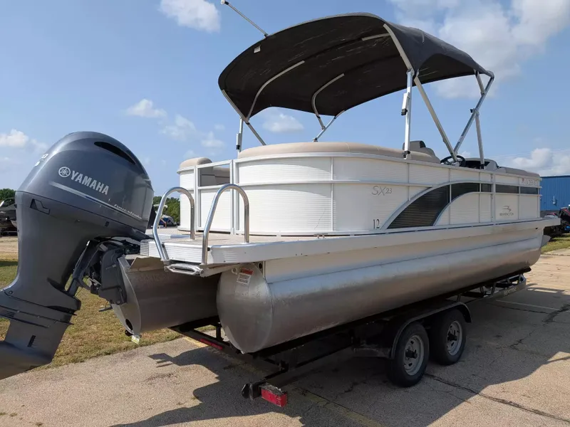 Slide: The Image of A 2019 Bennington 23 SSRXP pontoon boat with a Yamaha outboard motor on a trailer. - 8
