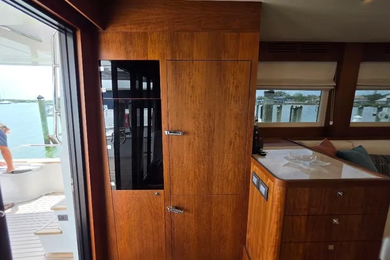 Slide: The Image of Interior of 2024 Sirena 58 Flybridge MY yacht with wooden cabinetry and waterfront view. - 64