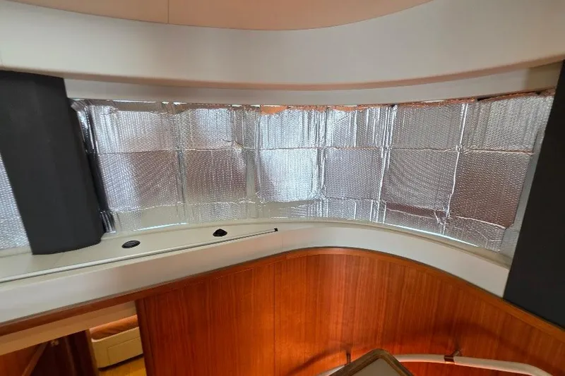 Slide: The Image of Interior view of 2024 Sirena 58 Flybridge MY yacht with reflective window coverings. - 86
