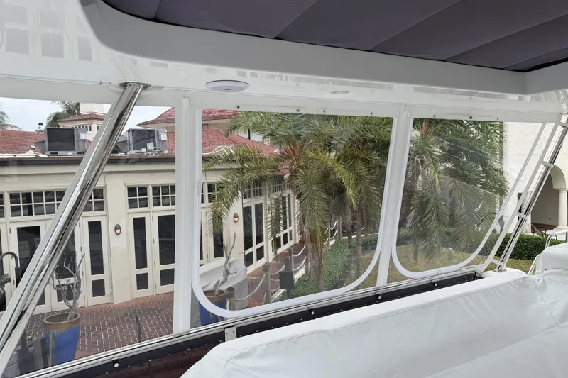 Slide: The Image of 2024 Sirena 58 Flybridge MY yacht interior with clear windows and outdoor view. - 46