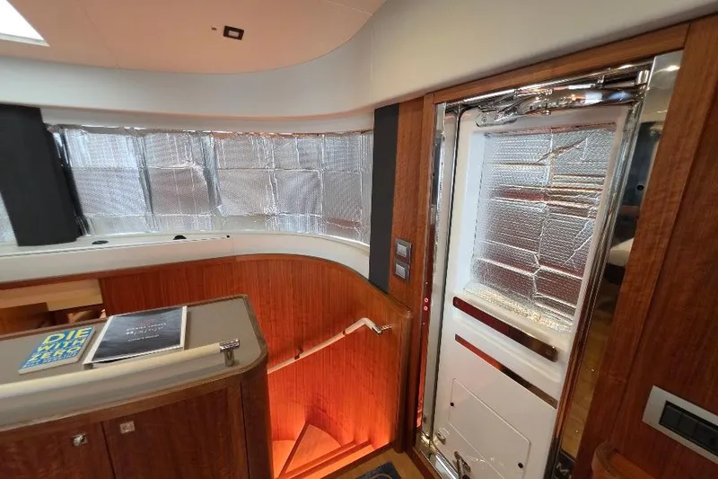 Slide: The Image of Interior of 2024 Sirena 58 Flybridge MY yacht with wood paneling and insulated windows. - 88