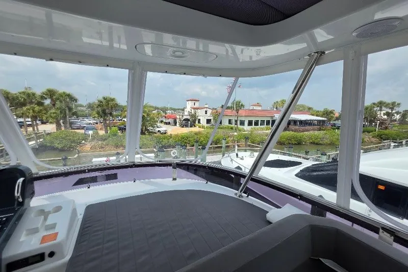 Slide: The Image of Interior view from 2024 Sirena 58 Flybridge MY yacht, overlooking marina and palm trees. - 33