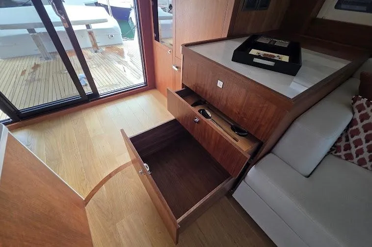 Slide: The Image of Interior of 2024 Sirena 58 Flybridge MY yacht with open wooden drawers and sliding glass door. - 69