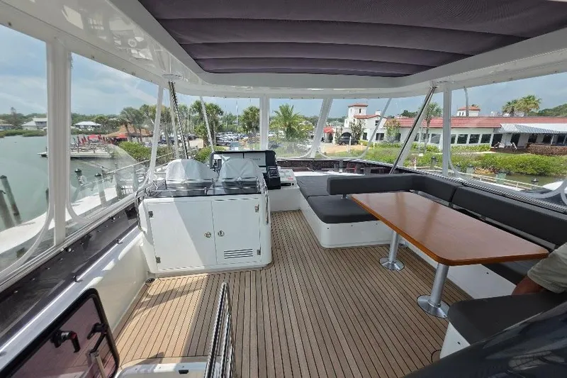 Slide: The Image of Luxurious 2024 Sirena 58 Flybridge MY yacht interior with seating and dining area. - 38