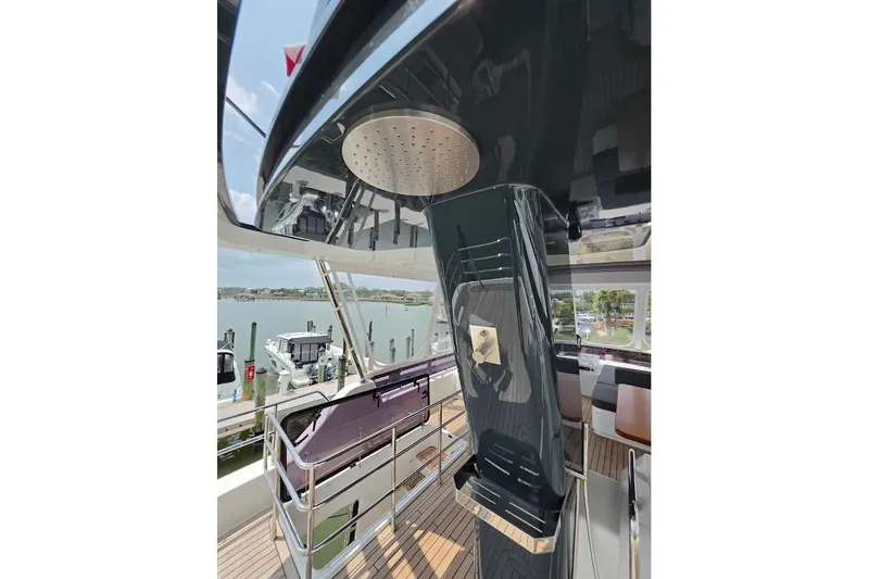 Slide: The Image of 2024 Sirena 58 Flybridge MY yacht deck with modern shower and seating area. - 48