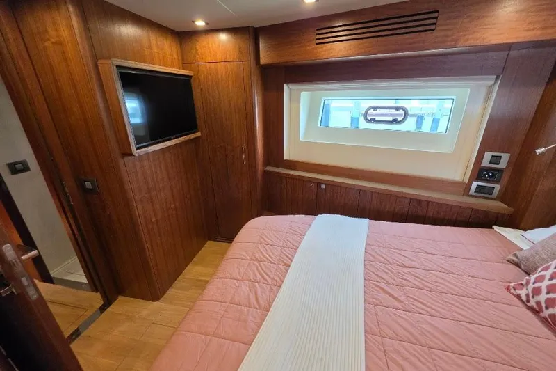 Slide: The Image of Luxurious cabin interior of 2024 Sirena 58 Flybridge MY yacht with wood paneling and window. - 103
