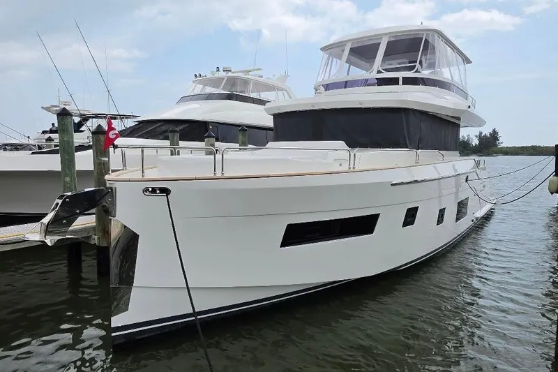 Slide: The Image of 2024 Sirena 58 Flybridge MY yacht docked in a marina, showcasing sleek design and modern features. - 3