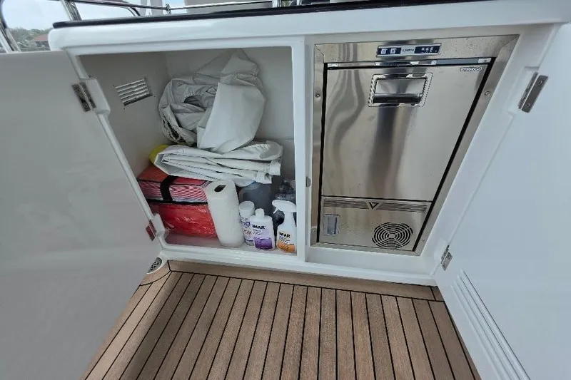 Slide: The Image of Open storage cabinet on 2024 Sirena 58 Flybridge MY yacht with cleaning supplies and equipment. - 57