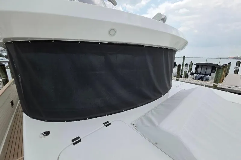 Slide: The Image of 2024 Sirena 58 Flybridge MY yacht with covered flybridge, docked at marina. - 6