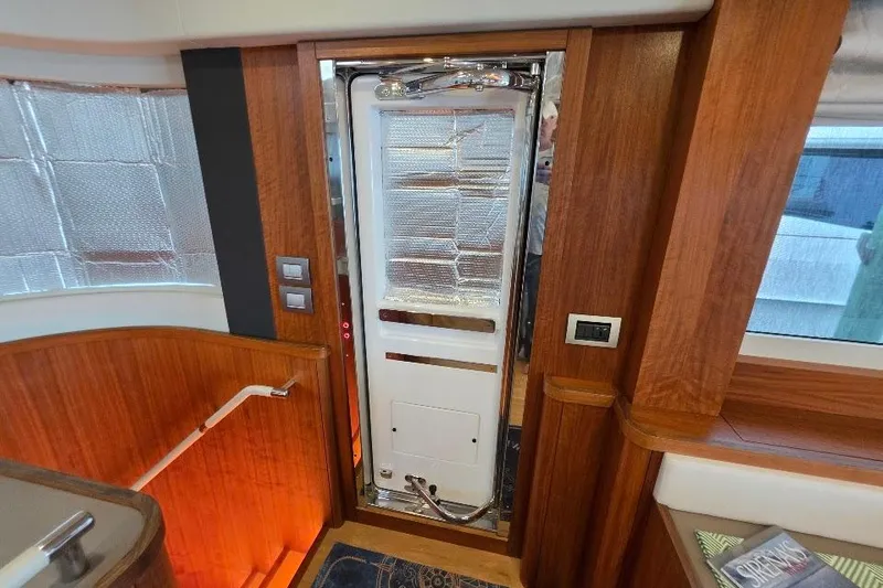 Slide: The Image of Interior of 2024 Sirena 58 Flybridge MY yacht with wooden finishes and modern design. - 87