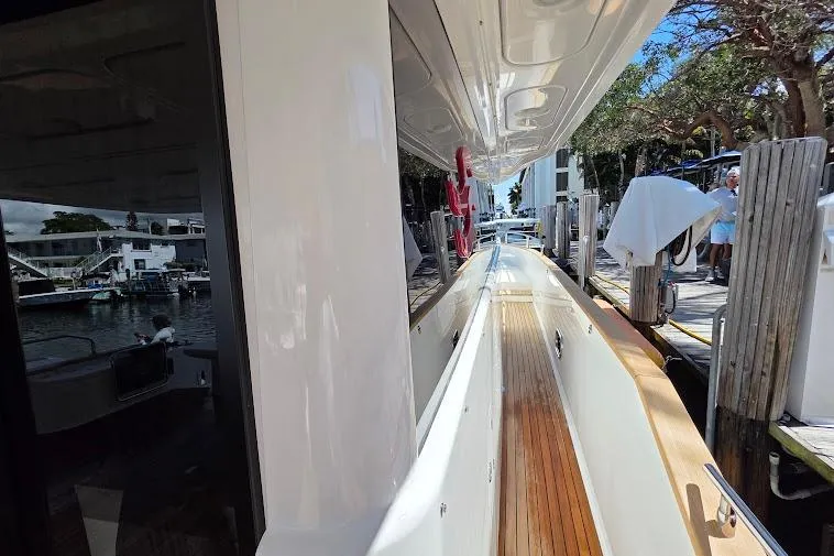Slide: The Image of 2024 Sirena 58 Flybridge MY yacht docked, showcasing sleek design and luxurious deck features. - 17