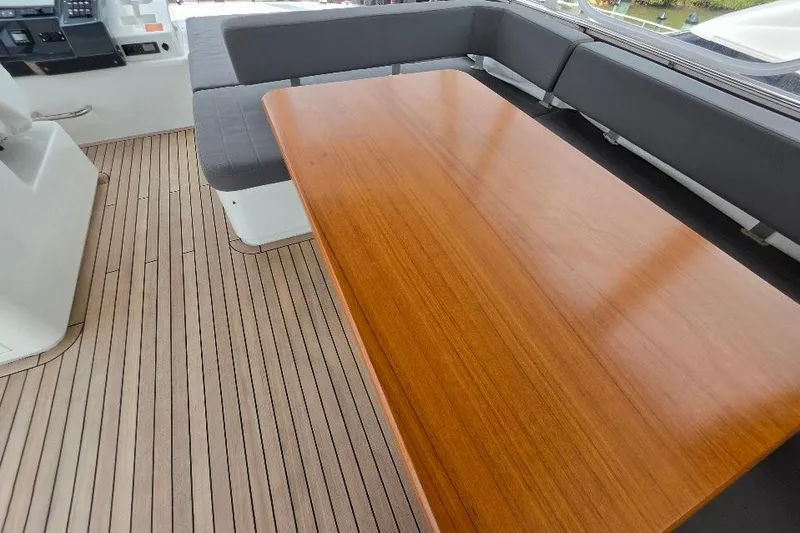 Slide: The Image of Luxurious seating area on 2024 Sirena 58 Flybridge MY yacht with wooden table. - 44