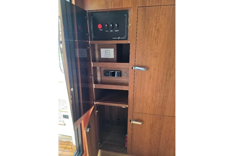 Slide: The Image of Wooden cabinet with control panel inside Sirena 58 Flybridge MY, 2024 model. - 66