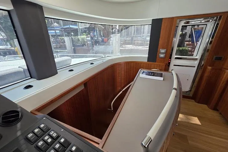 Slide: The Image of 2024 Sirena 58 Flybridge MY interior with modern helm and panoramic windows. - 92