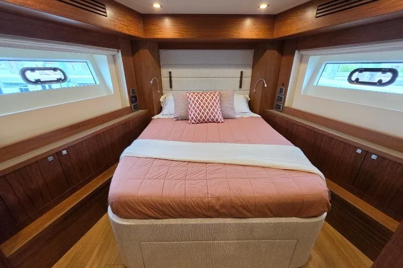 Slide: The Image of Luxurious bedroom interior of 2024 Sirena 58 Flybridge MY yacht with elegant wood finishes. - 101