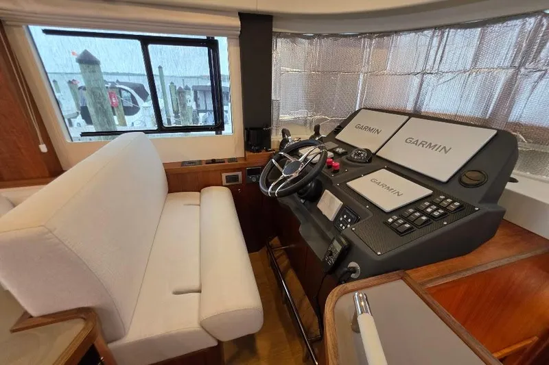Slide: The Image of 2024 Sirena 58 Flybridge MY helm with Garmin navigation displays and comfortable seating. - 81