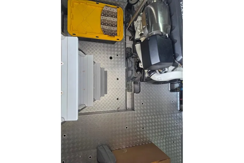 Slide: The Image of Engine room of 2024 Sirena 58 Flybridge MY with metal flooring and equipment. - 120