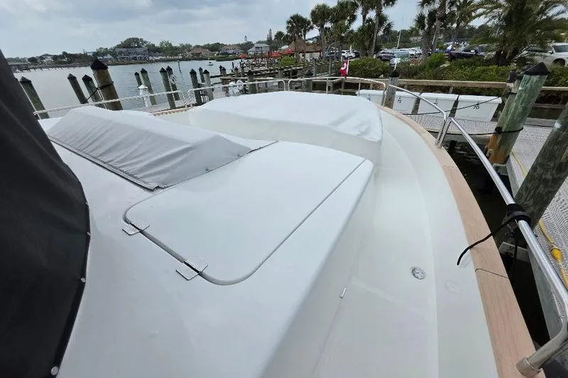 Slide: The Image of 2024 Sirena 58 Flybridge MY yacht docked, showcasing sleek deck design and waterfront view. - 22