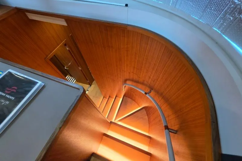 Slide: The Image of Elegant wooden spiral staircase inside 2024 Sirena 58 Flybridge MY yacht. - 97