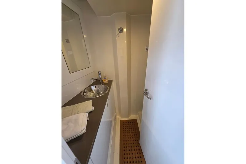 Slide: The Image of 2024 Sirena 58 Flybridge MY bathroom with sink, mirror, and shower area. - 117