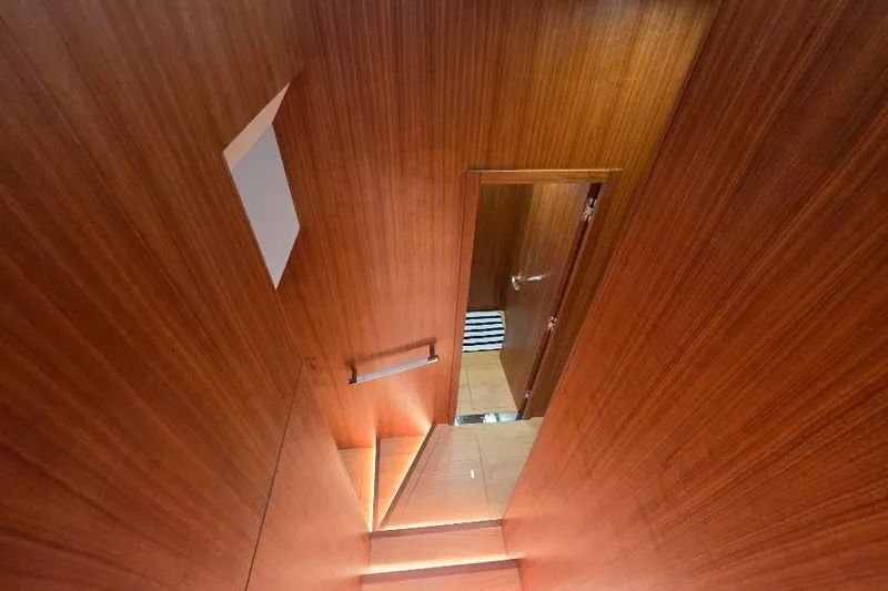 Slide: The Image of Interior staircase of 2024 Sirena 58 Flybridge MY yacht with wooden paneling. - 98