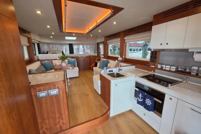 Slide: The Image of Luxurious interior of 2024 Sirena 58 Flybridge MY yacht with modern kitchen and seating area. - 62