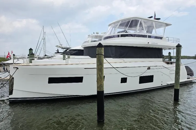 Slide: The Image of 2024 Sirena 58 Flybridge MY yacht docked at marina, showcasing sleek design and modern features. - 1