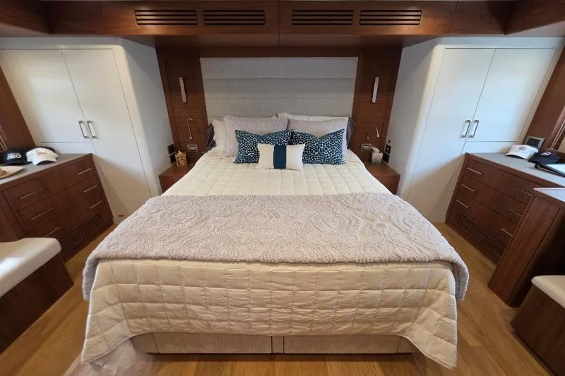 Slide: The Image of Luxurious bedroom interior of 2024 Sirena 58 Flybridge MY yacht with elegant bedding and wood accents. - 112