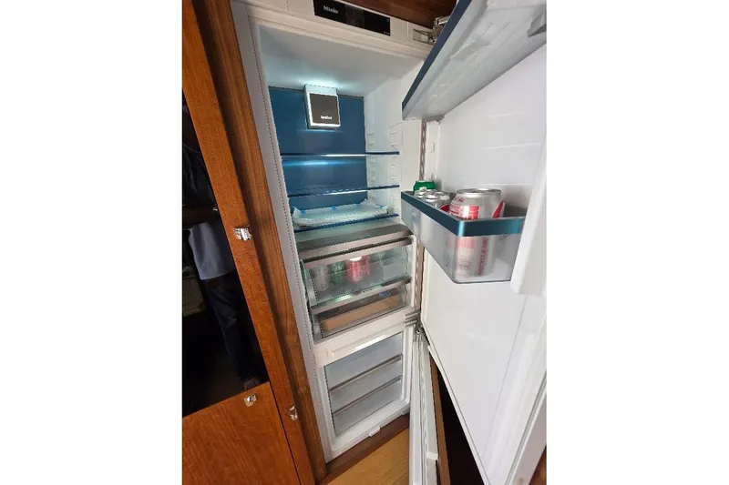 Slide: The Image of Open refrigerator on 2024 Sirena 58 Flybridge MY yacht, stocked with beverages. - 65