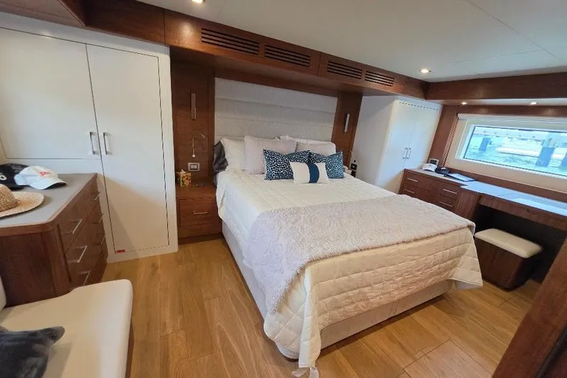 Slide: The Image of Luxurious bedroom interior of 2024 Sirena 58 Flybridge MY yacht with elegant wood finishes. - 113