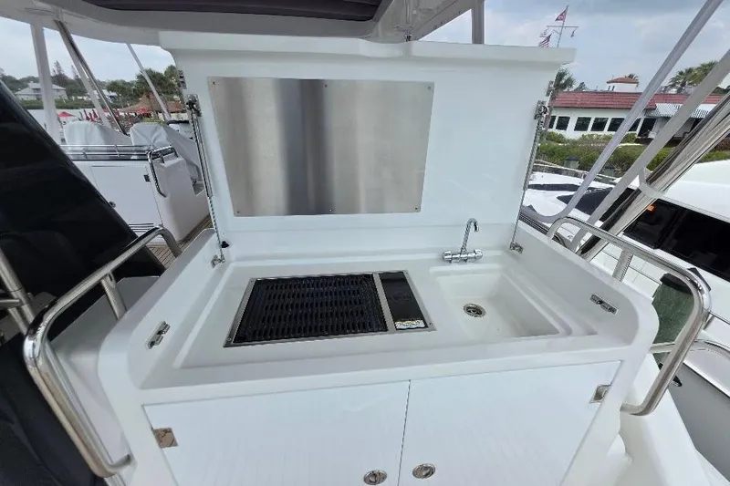 Slide: The Image of Outdoor kitchenette on 2024 Sirena 58 Flybridge MY yacht, featuring sink and grill. - 51