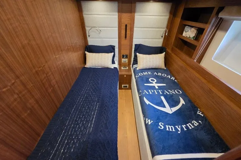 Slide: The Image of Twin cabin interior of 2024 Sirena 58 Flybridge MY yacht with nautical-themed bedding. - 111