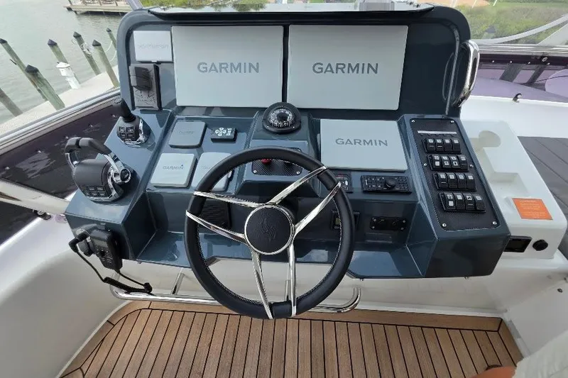 Slide: The Image of 2024 Sirena 58 Flybridge MY helm with Garmin navigation system and modern controls. - 29