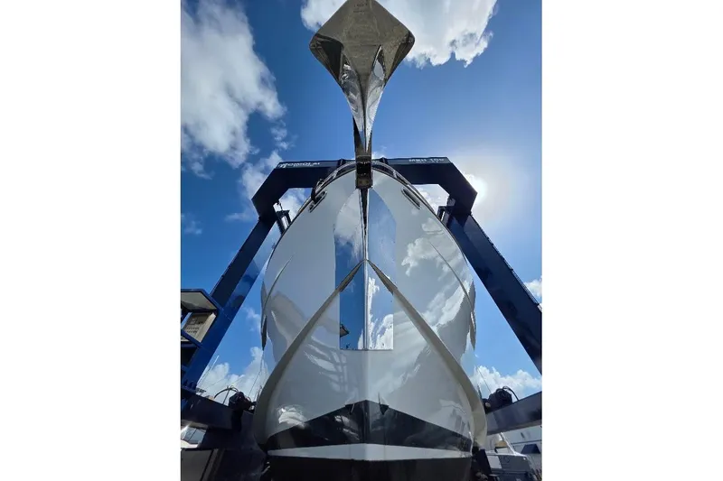 Slide: The Image of 2024 Sirena 58 Flybridge MY yacht under a clear blue sky, viewed from below. - 133